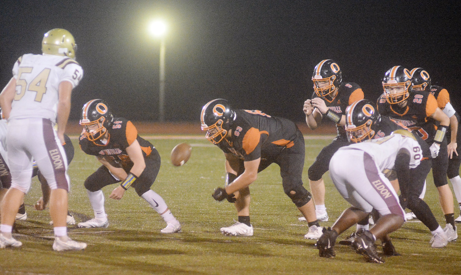 Blake Elliott (third from left) awaits the football after it was snapped by center Landon Kramme (above, second from left). Dutchmen lineman Hayden Shoemaker and Chance Clevenger wait for some Mustangs to block while Austin Long (20) and Tanner Meyer (hidden, far right) wait to see if they get to carry the football against Eldon.